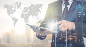 Double exposure of businessman using the tablet