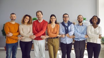 Diverse people group different generation and race ethnicity holding hands together demonstrating teamwork and teambuilding