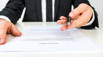 Businessman offering document for signing