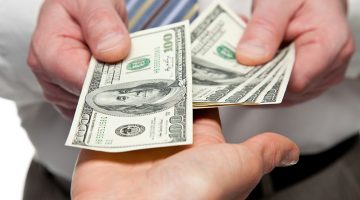 Human hands exchanging money
