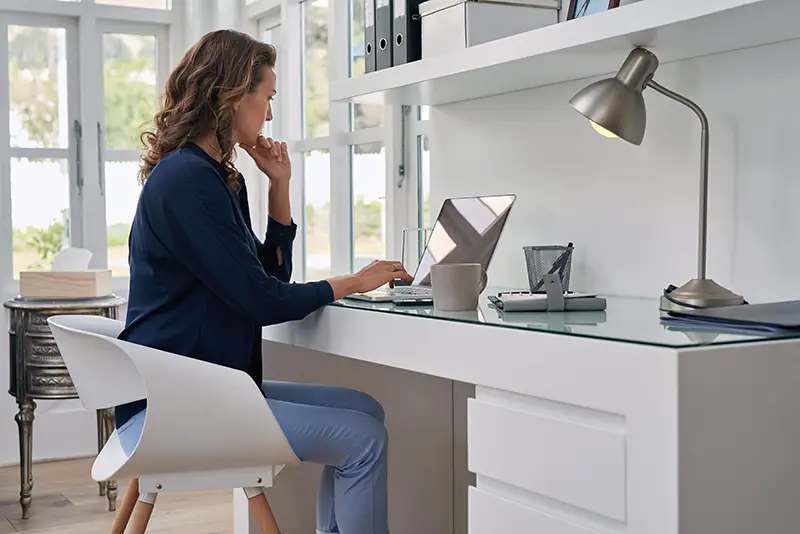 businesswoman entrepreneur working on laptop from home office space