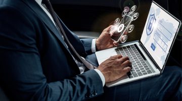 Cropped view of businessman using laptop and mobile phone