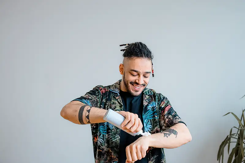 Man Putting Whipped Cream on His Arm