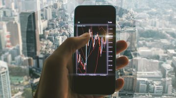 Close up on the smart phone with trading chart