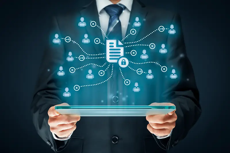 Corporate data management system (DMS) and document management system with privacy theme concept. Businessman or programmer with tablet and scheme with protected document connected with users, access rights symbolized by key.