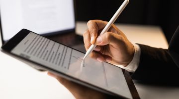 Man signing contract on tablet. Business and technology concept.