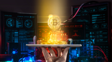 Hand holding mobile tablet with stack of bitcoin