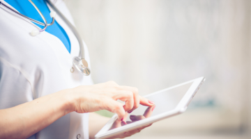 Doctor working on digital tablet