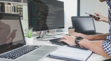Programmers cooperating at Developing programming website
