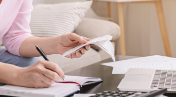 Cropped woman computing bills