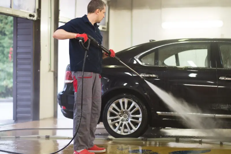 Man washing luxury car on a car wash