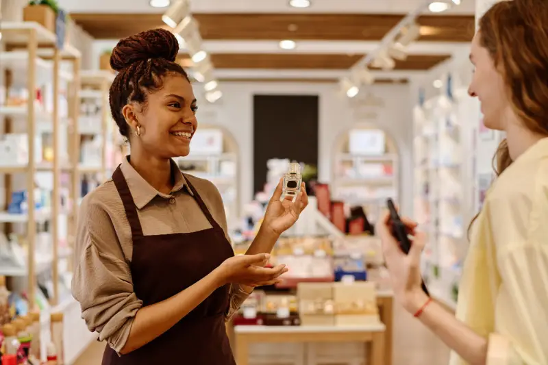 Young smiling saleswoman giving consultation to the customer