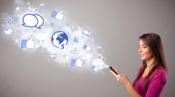 Young girl holding a phone with social media icons