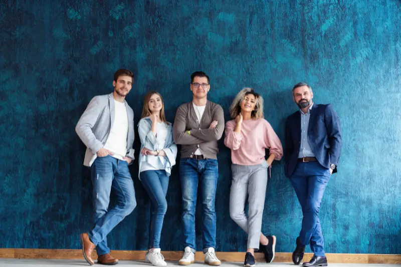 Portrait of creative business team standing together and laughing.
