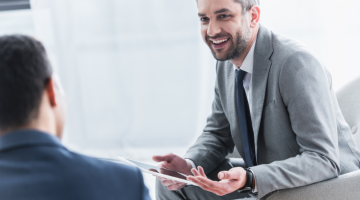 Smiling young businessman holding digital tablet