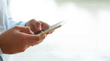 Hand of a person using mobile phone