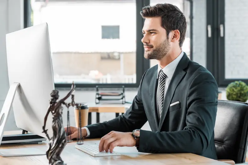Corporate lawyer working with computer at table office