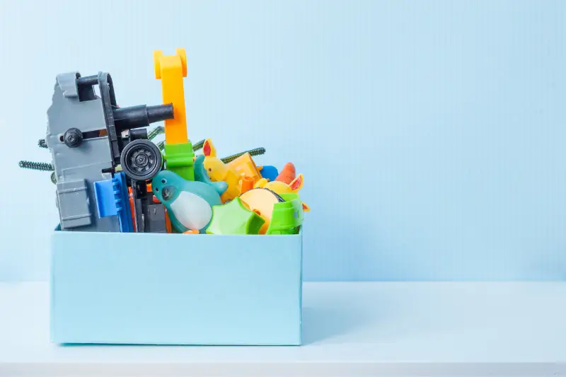 Box with old plastic toys for donate or recycle.