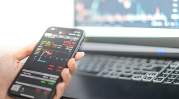 Trading graph on mobile phone and laptop screen