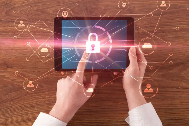 Hand using tablet with network security and online storage system