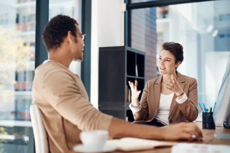 Mentor, training and a woman manager with an employee in the office for coaching on company vision.