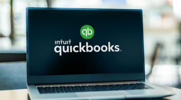 Computer laptop displaying Quickbooks accounting logo