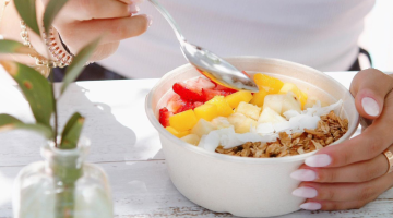 Woman eating breakfast before going to work