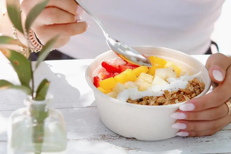 Woman eating breakfast before going to work