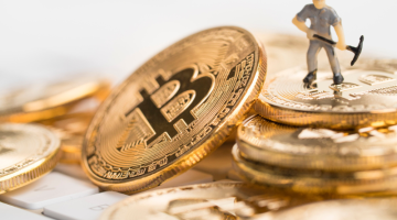Bitcoin mining concept with little figure on keyboard