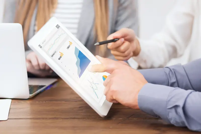 Web marketing managers with gadgets working on paid search and SEO strategies