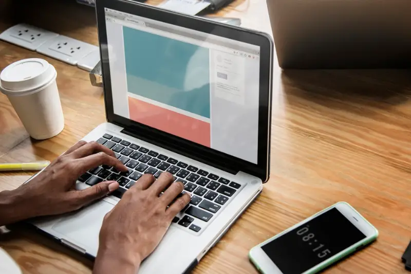 People working on a laptop in a meeting