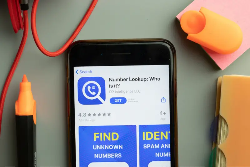 Phone screen close-up with Number Lookup mobile app logo on display