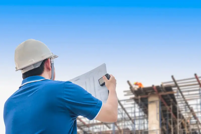Engineer is inspecting his work in building construction site