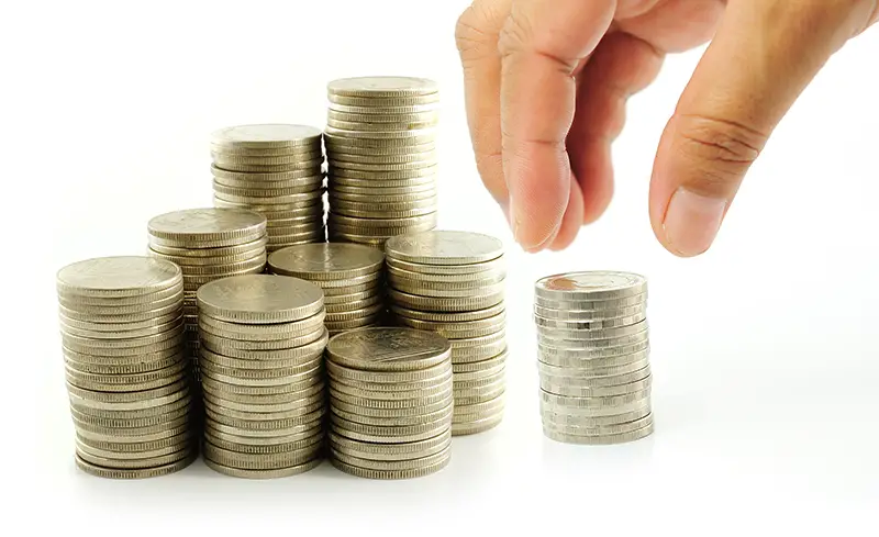 Finger put coin on coin-stack
