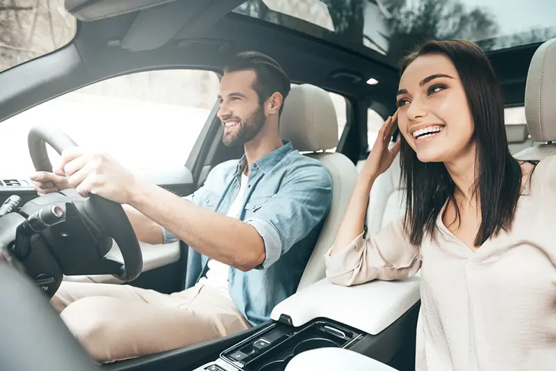 Beautiful couple driving car