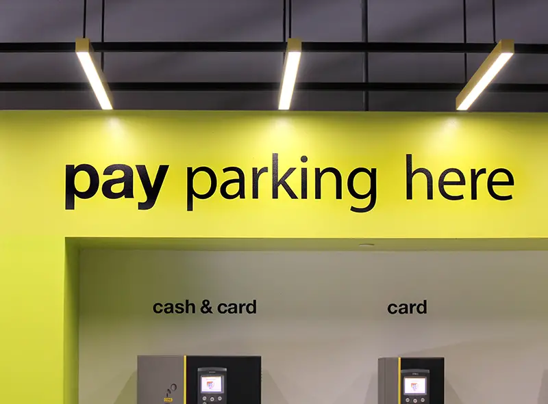 Pay Parking here signage in a public parking garage