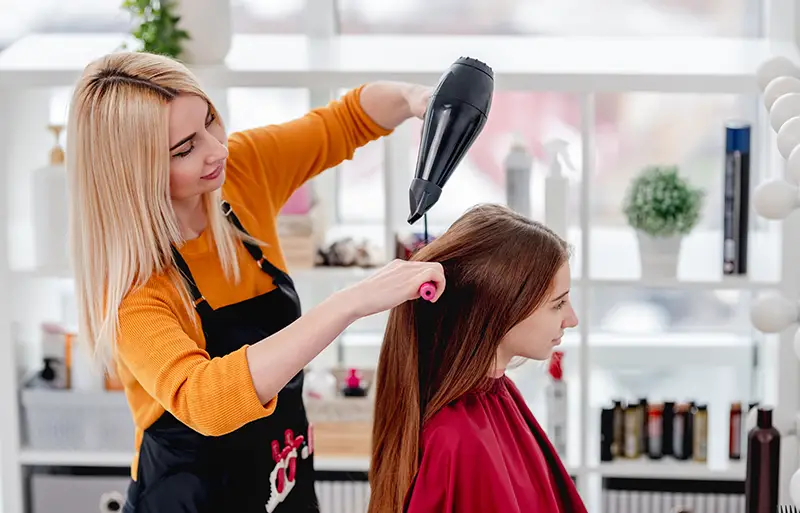 Hairdresser with hairdryer