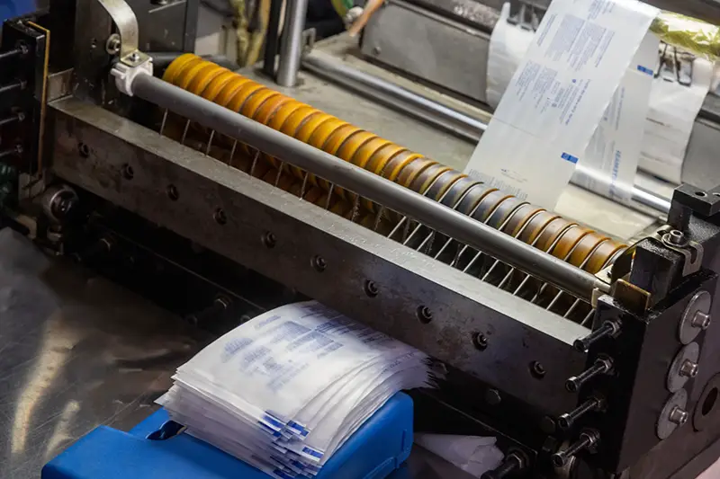 A closeup shot of a machine printing syringe labels