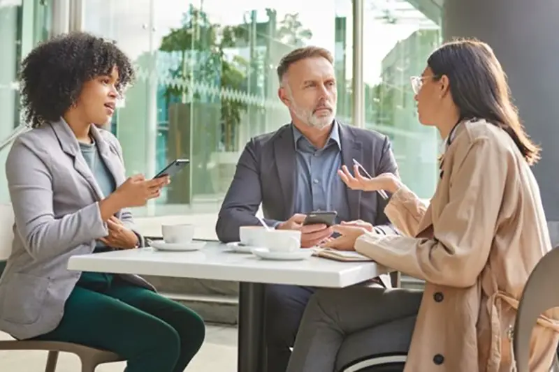 Group of colleagues brainstorming ideas at a coffeeshop
