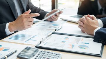 Business People Talking Discussing with coworker planning analyzing financial document data charts