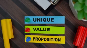 Unique Value Proposition write on sticky notes isolated on wooden table