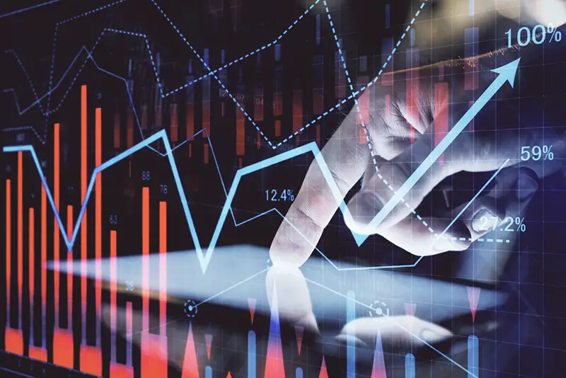 Double exposure of man's hands holding and using a digital device and forex graph drawing. Financial market concept.