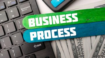 Keyboard,calculator and banknotes with the word BUSINESS PROCESS