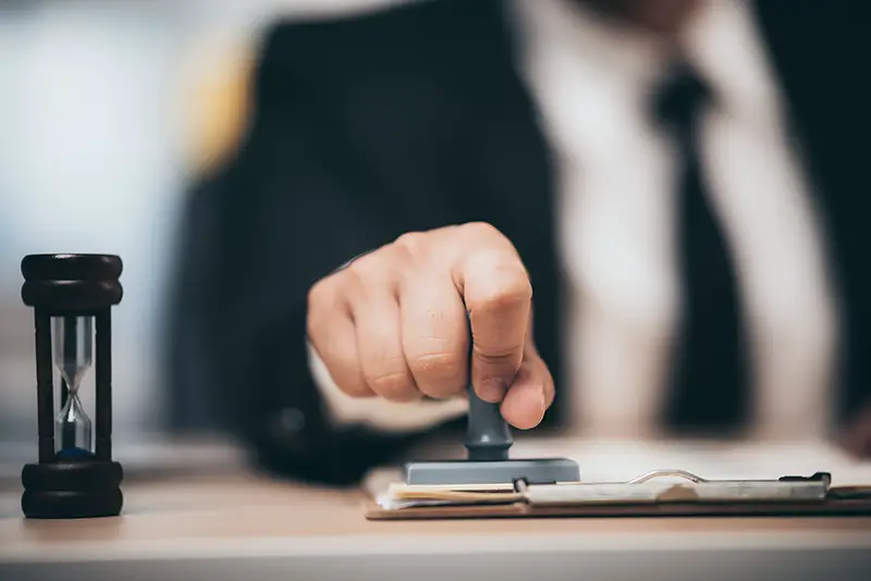 Young business man appoval stamper stamp on paper business contract, loan money approved.