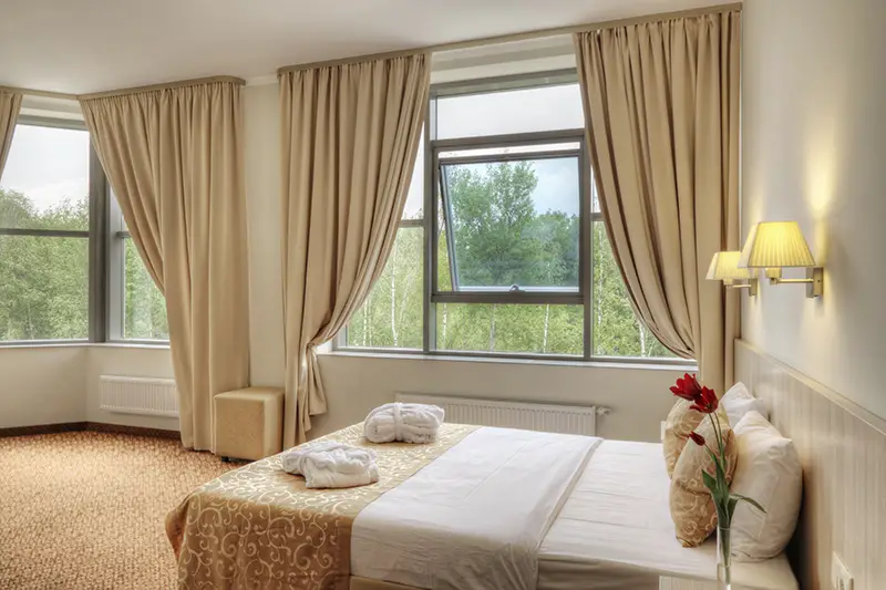 Bed and curtains in hotel room