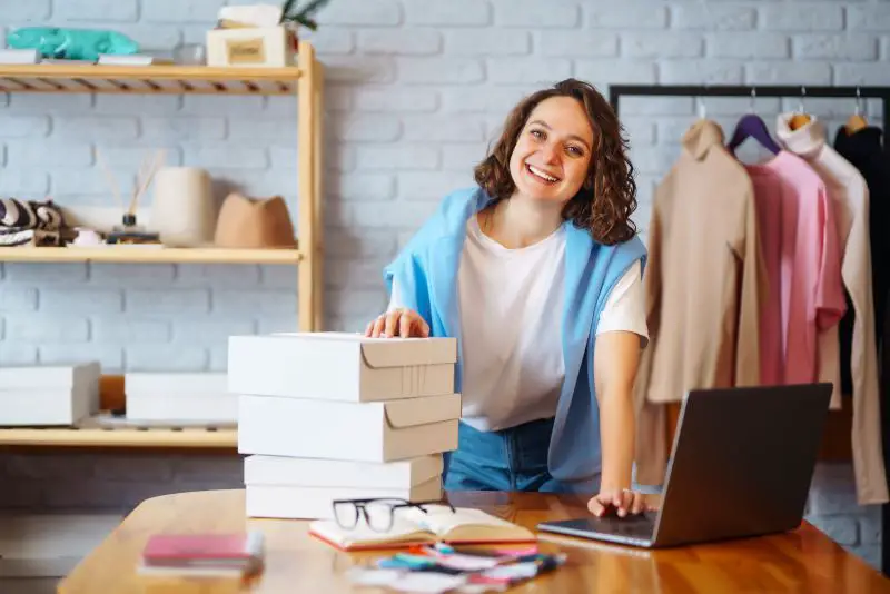 Small business owner, entrepreneur, seller using tablet checking ecommerce clothing store orders.