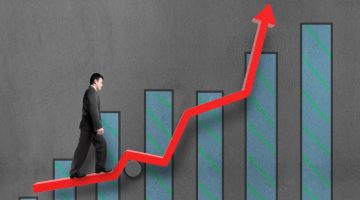 Businessman walking on growth red arrow with chart
