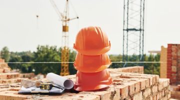 Close up view of protective hard hats that laying down on the bricks