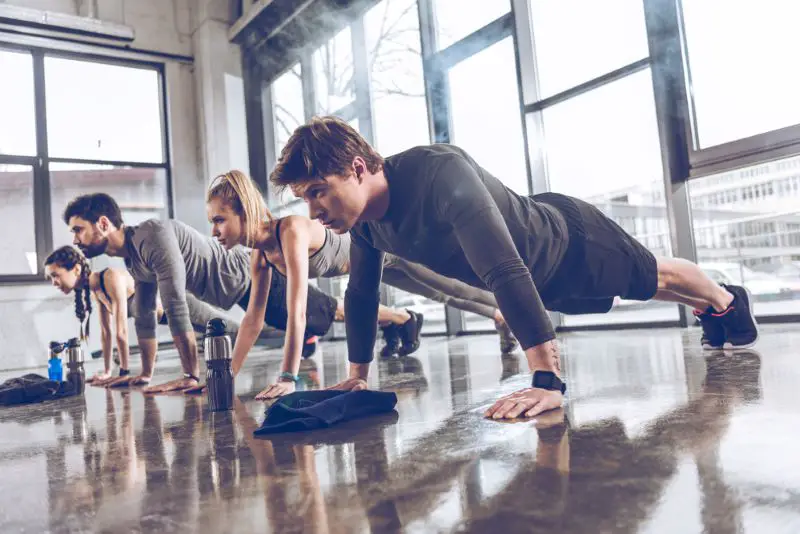 Sporty people exercising in gym