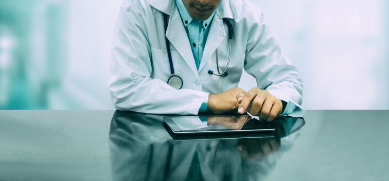 Doctor with tablet computer at hospital office